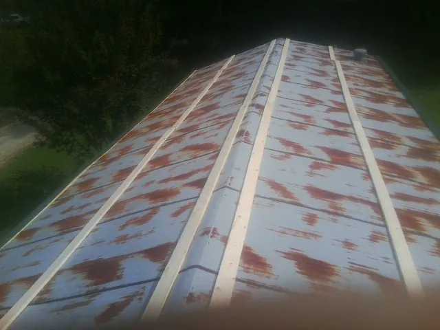 Rusted metal roof panels with new wood purlins before replacement — Storm Damage Roof Repair in Gas City by Roofing Brothers